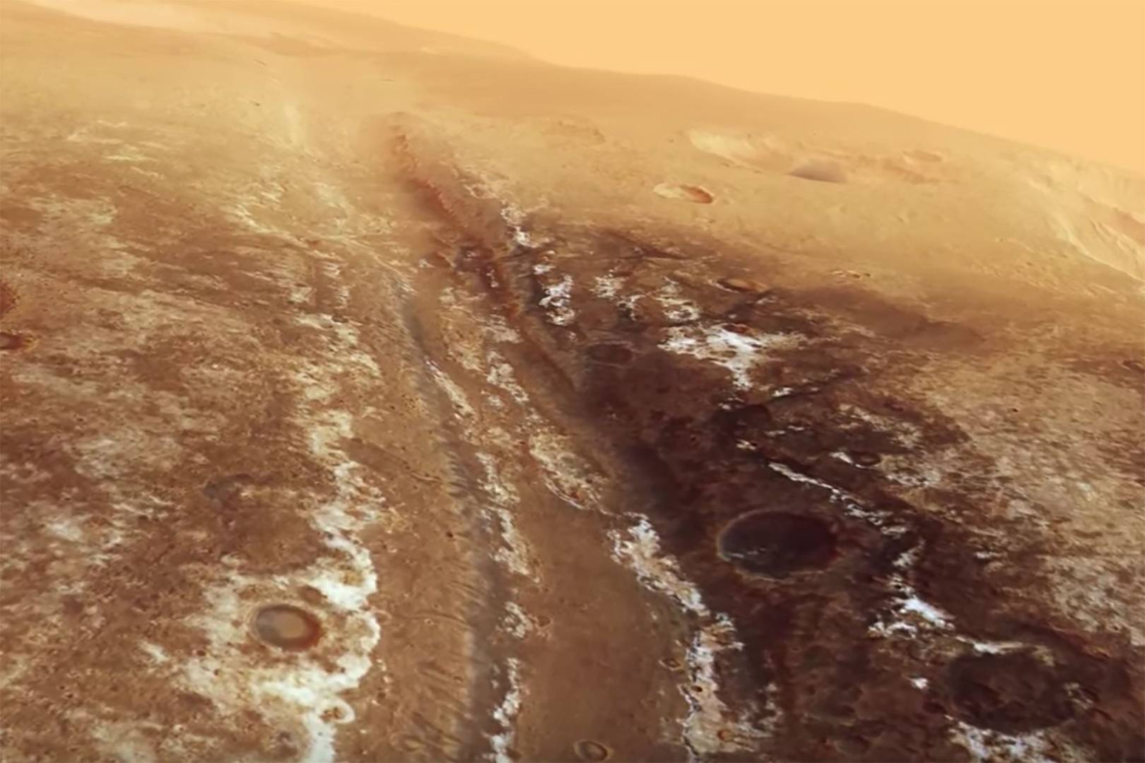 Soar above Mars' ravines and canyons in this fascinating Esa video