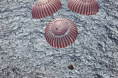 The Apollo 16 capsule descends into the Pacific Ocean