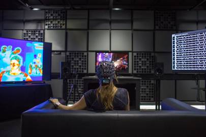 A viewer wearing EEG sensors watches TV in Dolby's biophysical lab